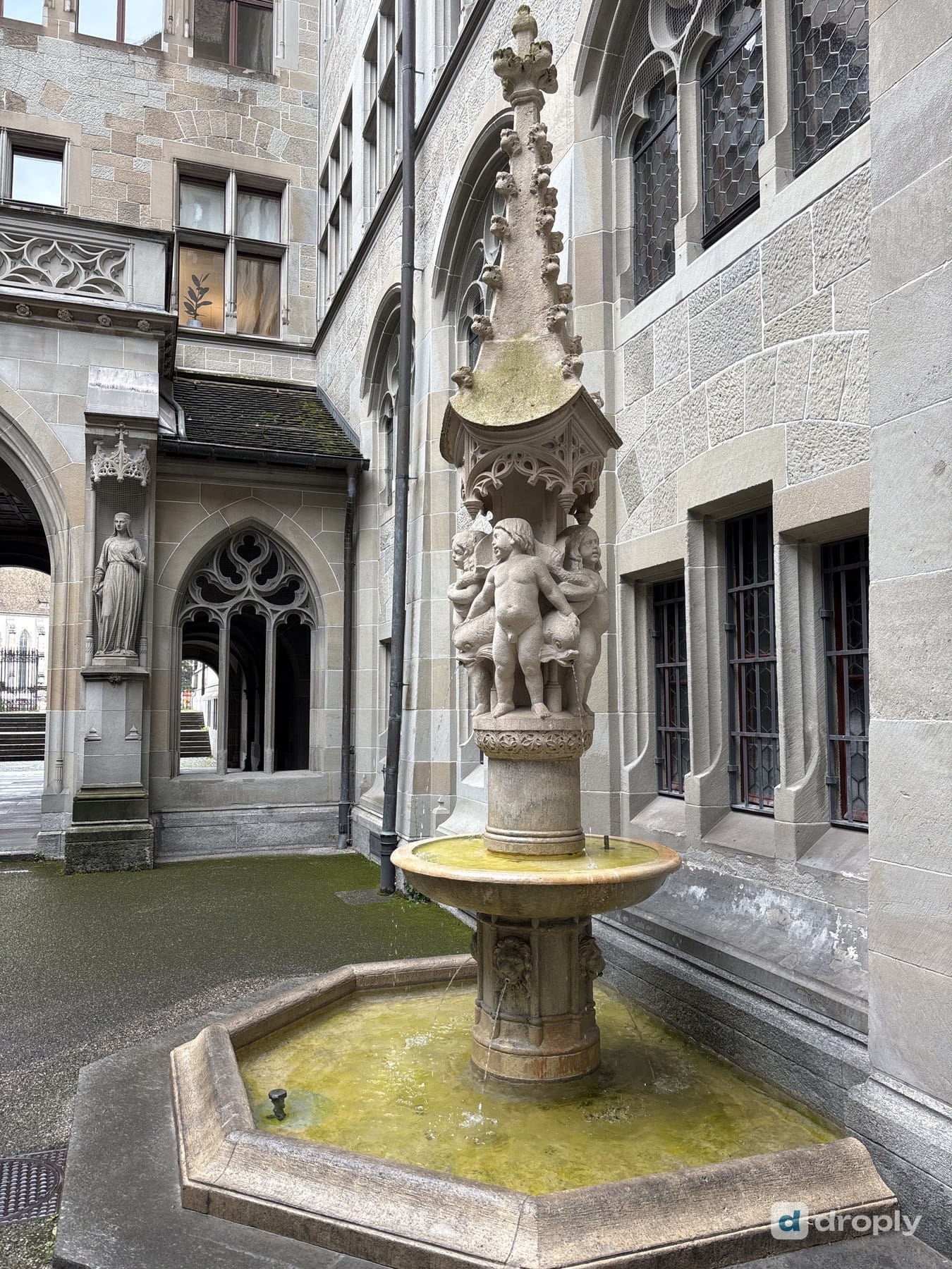 A stone trough fountain in the Fraumünster courtyard in Zurich