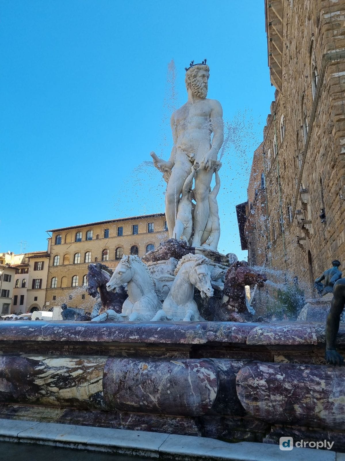 The Fontana del Nettuno fountain in Piazza della Signoria, Florence, with Palazzo Vecchio in the background
