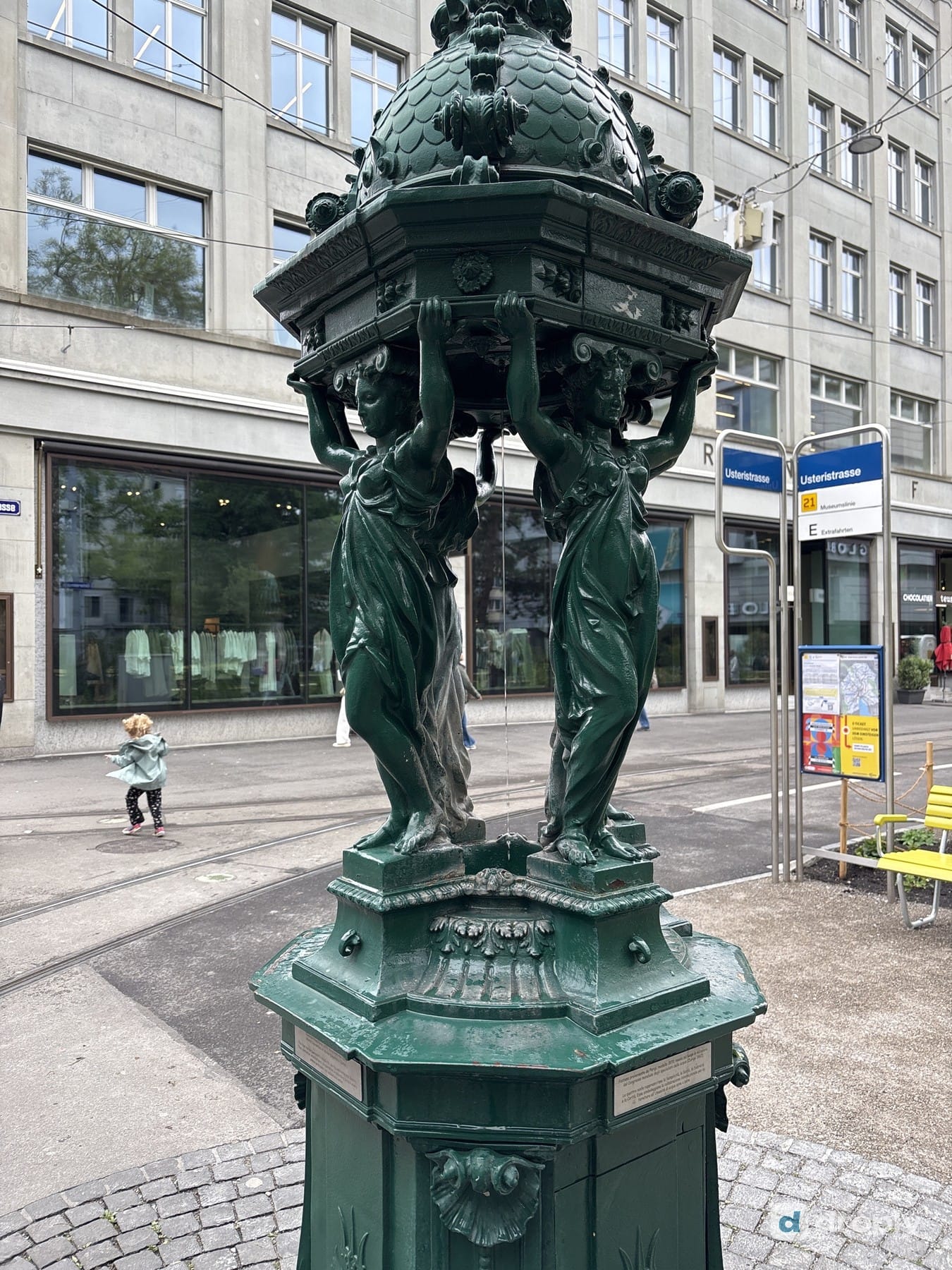 The green, wrought-iron Pariserbrunnen on Bahnhofstrasse in Zurich