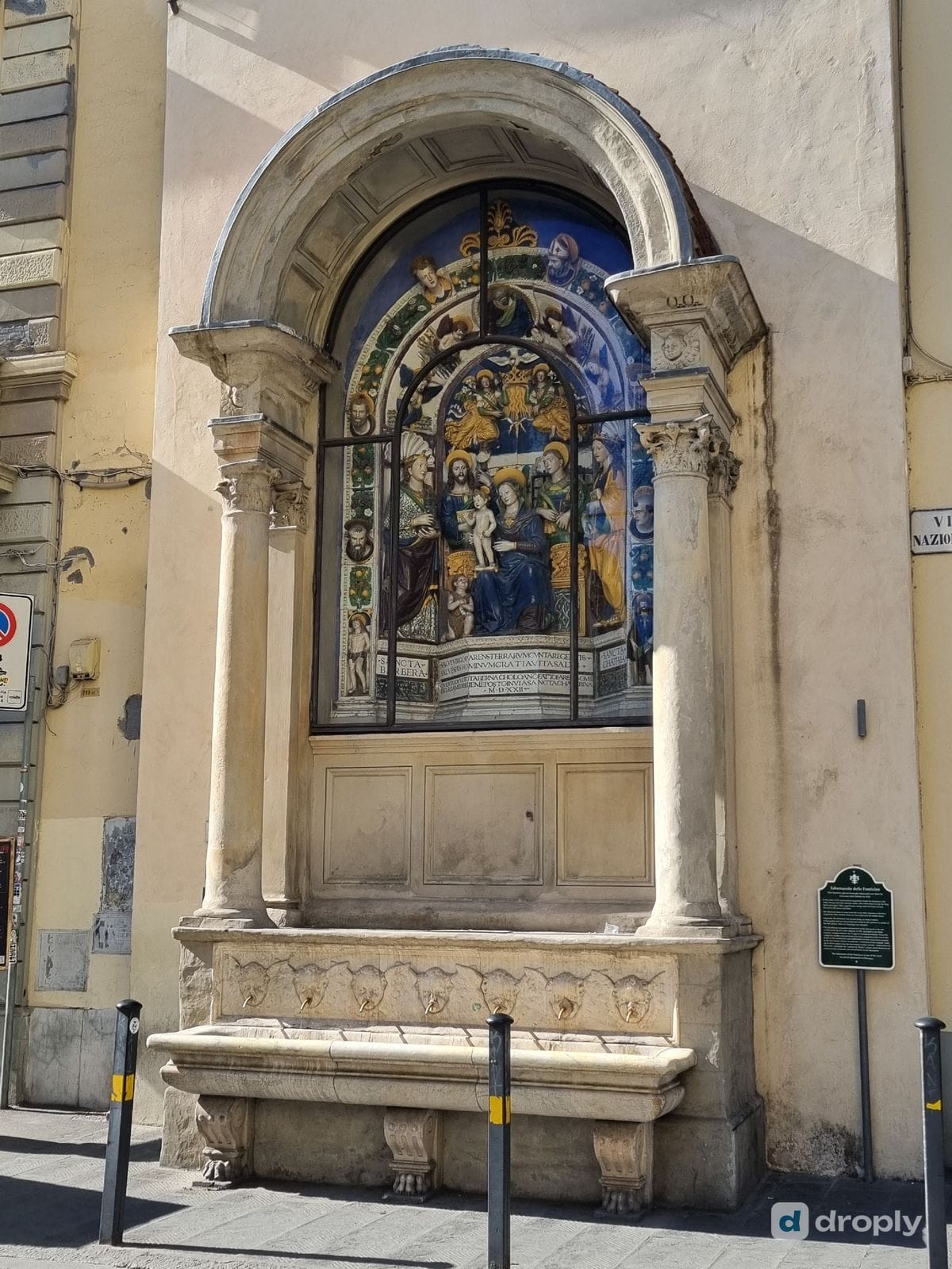 The Tabernacolo delle Fonticine, a 1522 glazed terracotta altarpiece by Girolamo della Robbia with a working stone fountain basin, in Florence