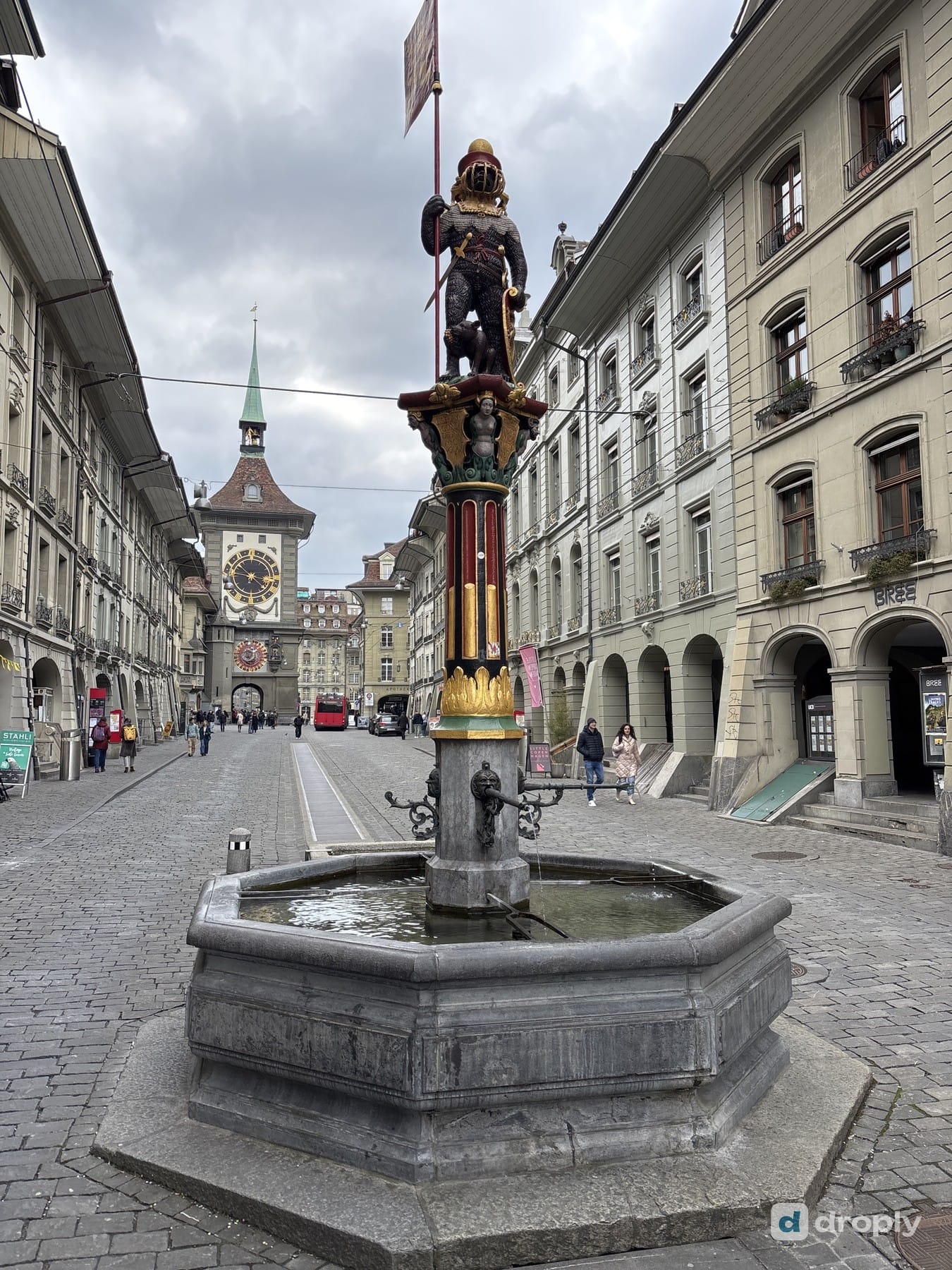 The Zähringer fountain with the armored bear on Kramgasse in Bern, with the Zytglogge clock tower in the background